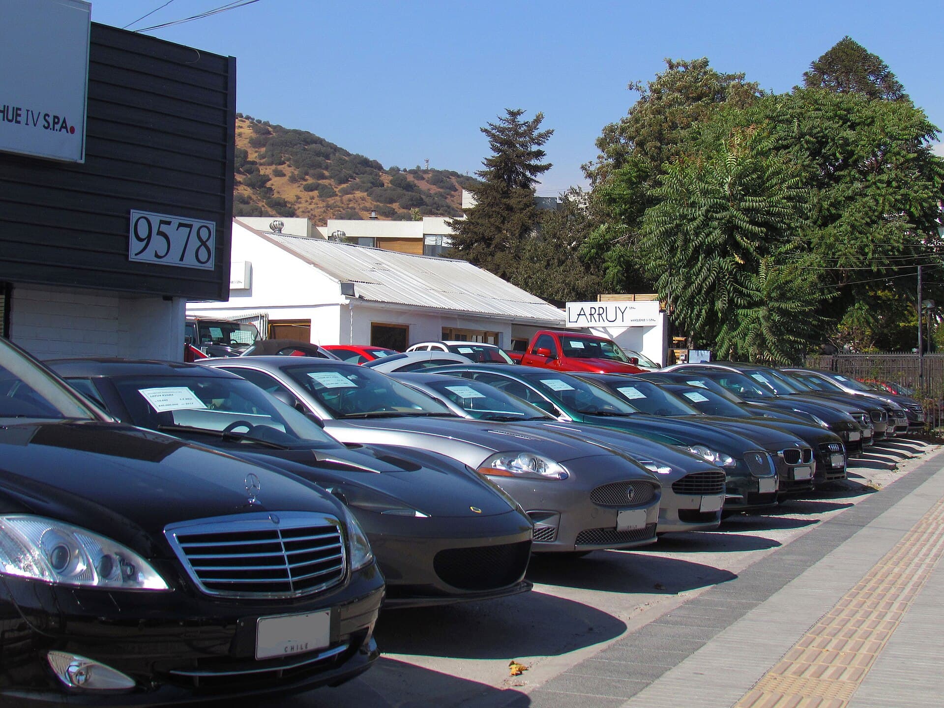 Rows of used cars parked at a dealership lot